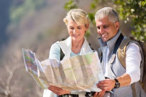 44302679 - happy senior hikers looking at map